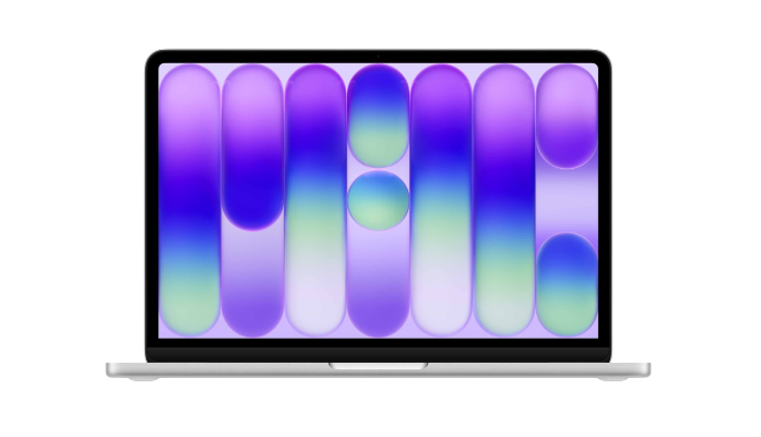 Silver laptop with a purple and green abstract screen.